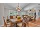 Elegant dining room with a large mirror wall and a classic chandelier at 146 Woodside Dr, Lakeland, FL 33813