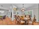 Formal dining room with an elegant chandelier and large windows at 146 Woodside Dr, Lakeland, FL 33813