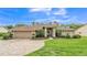 Charming single-story home with landscaped yard and brick-paved driveway under a blue sky at 146 Woodside Dr, Lakeland, FL 33813