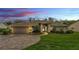 Charming single-story home with landscaped yard and brick-paved driveway under a colorful sunset at 146 Woodside Dr, Lakeland, FL 33813