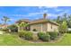 Exterior shot showcasing the house's landscaping and well-maintained garden beds at 146 Woodside Dr, Lakeland, FL 33813