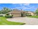 Beautiful home featuring a two-car garage, meticulously kept lawn and landscaping, and a stone driveway at 146 Woodside Dr, Lakeland, FL 33813