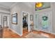Elegant foyer with tile flooring, a decorative mirror, and access to the office and living areas at 146 Woodside Dr, Lakeland, FL 33813