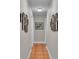 Hallway with neutral paint, tiled floors and decorative art displayed on the walls at 146 Woodside Dr, Lakeland, FL 33813