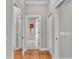 Hallway with neutral paint, tile floors, and white doors at 146 Woodside Dr, Lakeland, FL 33813