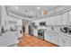 Bright kitchen featuring white cabinets, stainless steel appliances, and tile backsplash at 146 Woodside Dr, Lakeland, FL 33813