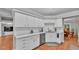 Well-lit kitchen featuring white cabinets, granite countertops, and stainless steel appliances at 146 Woodside Dr, Lakeland, FL 33813