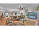 Open-concept living room with tile floors, comfortable seating, and views of the pool at 146 Woodside Dr, Lakeland, FL 33813