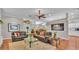 Spacious living room with tile flooring, comfortable sofas, and open access to the dining area and kitchen at 146 Woodside Dr, Lakeland, FL 33813