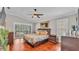 Comfortable main bedroom with a ceiling fan, hardwood floors, and backyard access at 146 Woodside Dr, Lakeland, FL 33813