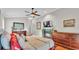 A beautifully styled bedroom features a fireplace, a ceiling fan, and ample natural light at 146 Woodside Dr, Lakeland, FL 33813