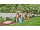 Backyard play area with a slide, swings, and a sandbox, perfect for Gathering fun at 146 Woodside Dr, Lakeland, FL 33813