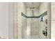 Updated shower featuring gray tile, rainfall shower head, and built-in soap niche at 146 Woodside Dr, Lakeland, FL 33813