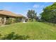 Spacious backyard perfect for outdoor activities with lush lawn, privacy fence, and mature landscaping at 1519 Blue Sky Blvd, Haines City, FL 33844