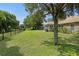Expansive backyard with a lush lawn and plenty of shade from mature trees, ideal for outdoor enjoyment at 1519 Blue Sky Blvd, Haines City, FL 33844