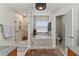Bright bathroom showcasing a walk-in shower and a soaking tub with decorative mosaic tile at 1519 Blue Sky Blvd, Haines City, FL 33844