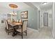Elegant dining room featuring a wooden table, chandelier, and an adjacent hallway at 1519 Blue Sky Blvd, Haines City, FL 33844