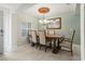 Elegant dining room with a wooden table and chandelier, with natural light from a window at 1519 Blue Sky Blvd, Haines City, FL 33844