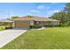 Charming single-story home featuring a well-maintained lawn and attached two-car garage at 1519 Blue Sky Blvd, Haines City, FL 33844