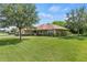Lovely single-story home with a well-kept lawn and mature trees, offering great curb appeal at 1519 Blue Sky Blvd, Haines City, FL 33844