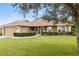 Beautiful home on a sprawling lawn with a 2-car garage and a charming covered front porch at 1519 Blue Sky Blvd, Haines City, FL 33844