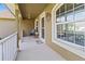 Inviting front porch with seating area and decorative wreath, creating a warm entrance at 1519 Blue Sky Blvd, Haines City, FL 33844