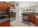 Well-lit kitchen with stainless steel appliances and granite countertops, flowing into the dining area at 1519 Blue Sky Blvd, Haines City, FL 33844