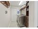 Laundry room featuring modern washer, dryer, shelving, and storage at 1519 Blue Sky Blvd, Haines City, FL 33844