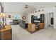 Bright living room featuring a vaulted ceiling, tile flooring, and comfortable seating arrangements at 1519 Blue Sky Blvd, Haines City, FL 33844