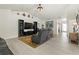 Open-concept living room with light tile flooring, a TV, and comfortable seating at 1519 Blue Sky Blvd, Haines City, FL 33844