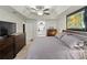 Comfortable main bedroom with a large TV and ensuite bathroom at 1519 Blue Sky Blvd, Haines City, FL 33844