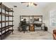 Spacious office area featuring a built-in desk, chair, and an abundance of shelving at 1519 Blue Sky Blvd, Haines City, FL 33844
