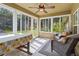 Bright sunroom featuring large windows, tiled floors, seating and fan at 1519 Blue Sky Blvd, Haines City, FL 33844
