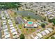 Aerial view of community amenities including pool, tennis courts, and lake at 1565 Heather Hill Dr, Lakeland, FL 33810