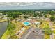 Community aerial showcasing a pool, lake, tennis courts, and manicured grounds at 1565 Heather Hill Dr, Lakeland, FL 33810