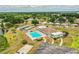 An aerial view of community amenities, including a pool, courts, parking, and an activity center at 1565 Heather Hill Dr, Lakeland, FL 33810