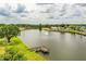 Aerial view showcasing a community lake, fountain, and surrounding landscaping at 1565 Heather Hill Dr, Lakeland, FL 33810