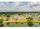 Aerial image featuring community pool, tennis and shuffleboard courts near a lake at 1565 Heather Hill Dr, Lakeland, FL 33810