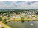 Aerial view of community amenities including pool, tennis courts, and lake at 1565 Heather Hill Dr, Lakeland, FL 33810