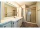Bathroom with neutral cabinets, a shower with sliding glass doors, and good lighting at 1565 Heather Hill Dr, Lakeland, FL 33810