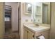 Traditional bathroom featuring a vanity with sink, mirror, and a view into the adjacent bedroom at 1565 Heather Hill Dr, Lakeland, FL 33810