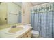 Bathroom featuring a sink, toilet, and patterned shower curtain at 1565 Heather Hill Dr, Lakeland, FL 33810