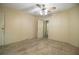 Empty bedroom with neutral decor, carpet flooring, ceiling fan and a view into an ensuite at 1565 Heather Hill Dr, Lakeland, FL 33810