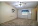 Bedroom with neutral walls, carpet flooring, a ceiling fan, and a window with blue curtains at 1565 Heather Hill Dr, Lakeland, FL 33810