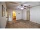 Bedroom with wallpaper, ceiling fan, carpet, and access to an ensuite bathroom at 1565 Heather Hill Dr, Lakeland, FL 33810