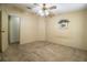 Neutral bedroom with carpet flooring, ceiling fan, adjacent room view, and picture on wall at 1565 Heather Hill Dr, Lakeland, FL 33810