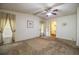 Carpeted bedroom with a window, ceiling fan, and an ensuite bathroom at 1565 Heather Hill Dr, Lakeland, FL 33810