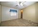 Bedroom with carpet flooring, neutral walls, ceiling fan and a window at 1565 Heather Hill Dr, Lakeland, FL 33810