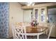 Close-up of a dining table with a floral centerpiece, complemented by floral wallpaper at 1565 Heather Hill Dr, Lakeland, FL 33810