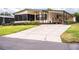 Well maintained single-Gathering home with front yard and long driveway leading up to the front entryway at 1565 Heather Hill Dr, Lakeland, FL 33810
